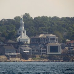 a large body of water with a city in the background